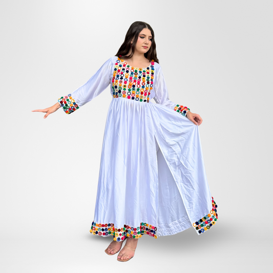 Woman wearing a white traditional dress with colorful circular mirror embroidery in red, blue, green, yellow, and multicolored patterns on the bodice, sleeves, and hem, Rang-e-Noor.