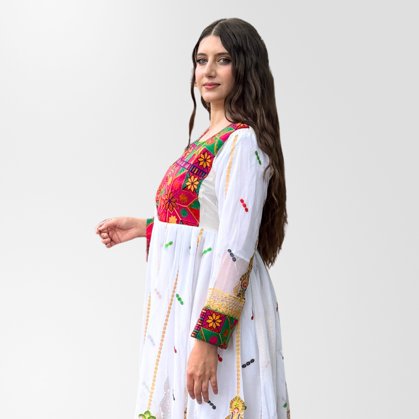 Woman wearing a traditional embroidered outfit on a white background